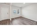 Light-filled room with two windows and wood-look flooring at 110 Obadiah Ct, Mooresville, NC 28115
