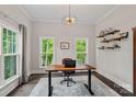 Bright office space with large windows, a modern desk, and custom shelving at 112 Nautilus Ct, Troutman, NC 28166