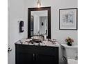 Stylish powder room with a vessel sink, granite countertop, and decorative mirror at 112 Nautilus Ct, Troutman, NC 28166