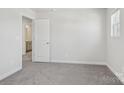 Bright bedroom with neutral carpet and walls, perfect for creating a relaxing retreat at 113 Obadiah Ct, Mooresville, NC 28115