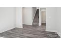 Open-concept living room showcasing gray wood-look floors and white trim at 113 Obadiah Ct, Mooresville, NC 28115