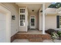 Inviting front porch with brick base and sidelight windows, offering a warm welcome at 12013 Regent Ridge Ln, Charlotte, NC 28278