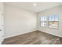 An empty bedroom with wood-look floors and two windows allowing natural light at 1210 Morehead Dr, Salisbury, NC 28144