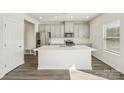 Bright, modern kitchen with stainless steel appliances, gray cabinets, and a large island with a white countertop at 1210 Morehead Dr, Salisbury, NC 28144