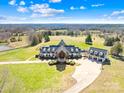 Sprawling estate with lush green pastures, stately house, and circular driveway at 12613 B Oak Grove Rd, Stanfield, NC 28163