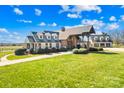 Beautiful house with a well-maintained lawn and an attached three-car garage at 12613 B Oak Grove Rd, Stanfield, NC 28163