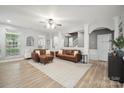 Open living room with stylish furnishings, wood floors, and ample natural light, perfect for relaxation and entertaining at 13032 Windy Lea Ln, Huntersville, NC 28078