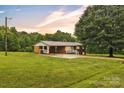 Charming brick home with a metal roof on a large lawn at 133 Jo Monni Loop, Statesville, NC 28625