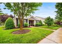 Beautiful home with stone accents, lush landscaping, and a well-maintained front lawn at 13407 Hazelbrook Ln, Cornelius, NC 28031