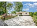 Inviting front exterior showcasing a well-maintained lawn, wide driveway, and classic architectural details at 1406 W Walnut Ave, Gastonia, NC 28052