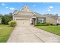 Inviting home with a neatly manicured lawn, enhanced by colorful landscaping, creating an attractive curb appeal at 1409 Tupelo Rd, Clover, SC 29710