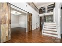 Grand foyer with hardwood floors, staircase, and open doorway at 15637 Guthrie Dr, Huntersville, NC 28078