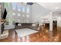 Spacious living room with stone fireplace, hardwood floors, and ample natural light at 15637 Guthrie Dr, Huntersville, NC 28078