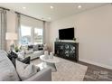 Cozy living room with large windows, plush seating, and stylish decor at 1712 Braemar Village Dr, Monroe, NC 28110