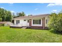 Inviting single-story home featuring a brick foundation, covered porch, and lush green lawn at 1725 Fallston Rd, Shelby, NC 28150