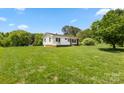 Spacious front yard with a single-story home, mature trees, and lush green grass at 1725 Fallston Rd, Shelby, NC 28150
