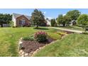 Attractive brick home with mature landscaping and a well-maintained lawn at 1759 Nw Pipers Ridge Cir, Conover, NC 28613