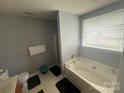 Bright bathroom with a tub, a vanity and a window for natural light at 181 Mott Rd, Mooresville, NC 28115
