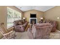 Spacious living room features a cozy fireplace, large window, and comfortable seating at 181 Mott Rd, Mooresville, NC 28115
