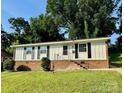 Charming single-story home featuring black window shutters and a well-maintained front yard at 2020 Longleaf Dr, Charlotte, NC 28210