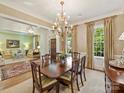 Elegant dining room with chandelier, hardwood floors, and formal furnishings at 2129 Halford Pl, Charlotte, NC 28211