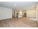 Open-concept living area flows into kitchen, featuring hard surface floors and ample natural light at 2155 Sunflower Cir, Newton, NC 28658