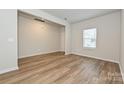 Bright living room with neutral paint and wood flooring, featuring a large window at 2159 Sunflower Cir, Newton, NC 28658