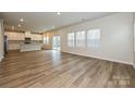 Expansive living area with wood floors, flowing into a white kitchen and dining area at 2159 Sunflower Cir, Newton, NC 28658