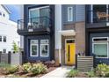Charming townhome with a welcoming yellow front door and well-maintained landscaping, creating curb appeal at 2254 Electric Ln, Charlotte, NC 28205