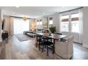 Open-concept living and dining area with hardwood floors and plenty of natural light, perfect for Gathering gatherings at 2254 Electric Ln, Charlotte, NC 28205