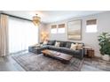 Comfortable living room with plush sectional sofa, stylish rug, and elegant chandelier, perfect for relaxation at 2254 Electric Ln, Charlotte, NC 28205