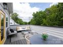 Inviting outdoor patio with string lights, comfortable seating, and a peaceful view of lush greenery at 2254 Electric Ln, Charlotte, NC 28205