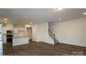 Open-concept living area with hardwood floors and staircase at 3156 Lilac Grove Dr, Charlotte, NC 28269