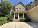Charming brick home featuring a welcoming front porch and two-car garage at 3825 Mountain Cove Dr, Charlotte, NC 28216