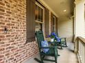 Inviting front porch with rocking chairs, perfect for relaxing outdoors at 3825 Mountain Cove Dr, Charlotte, NC 28216