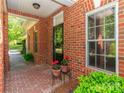 Inviting covered brick entryway adorned with decorative potted plants and exterior trim details at 532 Wilmslow Rd, Rock Hill, SC 29730