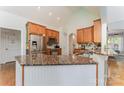 Lovely kitchen with stainless appliances, wood cabinets, granite countertops, and decorative tile backsplash at 6603 Havencrest Dr, Denver, NC 28037