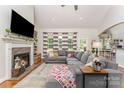 Comfortable living room with fireplace, hardwood floors, and an abundance of natural light at 6603 Havencrest Dr, Denver, NC 28037