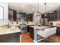 Modern kitchen with a central island, pendant lighting, and stainless steel appliances at 7318 Agnew Dr, Charlotte, NC 28278