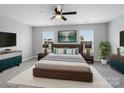 The main bedroom features ample natural light, neutral walls, a ceiling fan, and an elegant accent wall at 908 Sundance Dr, Gastonia, NC 28054