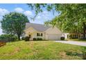 Charming home featuring a manicured front lawn and an attached two-car garage at 9711 Castle Terrace Ct, Charlotte, NC 28215