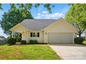 Charming home featuring a manicured front lawn and an attached two-car garage at 9711 Castle Terrace Ct, Charlotte, NC 28215