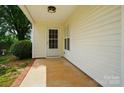 Covered patio showcasing a cozy outdoor space with brick-lined flooring at 9711 Castle Terrace Ct, Charlotte, NC 28215