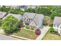 Aerial view of a distinguished brick home showcasing its manicured lawn and neighborhood at 1031 Butterburr Dr, Matthews, NC 28104