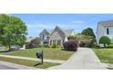 Beautifully landscaped front yard with a traditional brick home, complemented by a long driveway at 1031 Butterburr Dr, Matthews, NC 28104