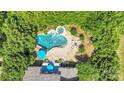 Aerial view of a stunning backyard oasis featuring a large pool, hot tub, and outdoor seating area at 1031 Butterburr Dr, Matthews, NC 28104
