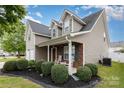 Charming two-story home with landscaped front yard, covered porch, and neutral siding and brick details at 108 Copes Ct, Rock Hill, SC 29732