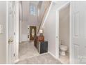 Bright foyer features high ceilings, stairs, tile floors, half bathroom, and a beautiful front door at 108 Copes Ct, Rock Hill, SC 29732