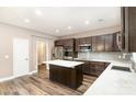 Modern kitchen featuring stainless steel appliances, a kitchen island and dark cabinetry at 11109 Amur Ct, Charlotte, NC 28262
