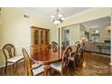 Bright dining room showcasing a wooden hutch, chandelier, and hardwood floors at 1117 Yarrow St, Matthews, NC 28104